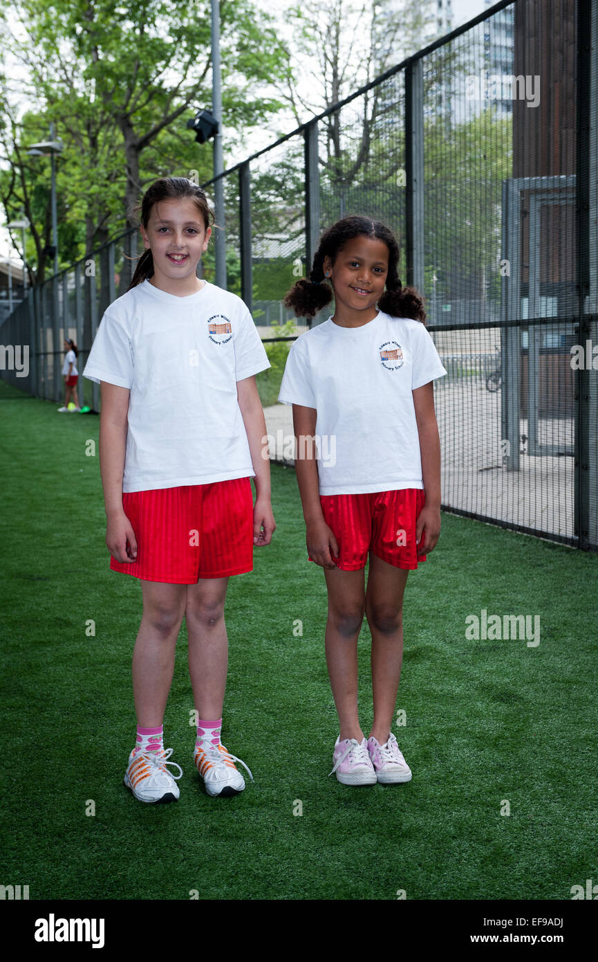 Primary school  girls in their school sports kit London UK at a sports pitch under the Westway, Paddington,London Stock Photo