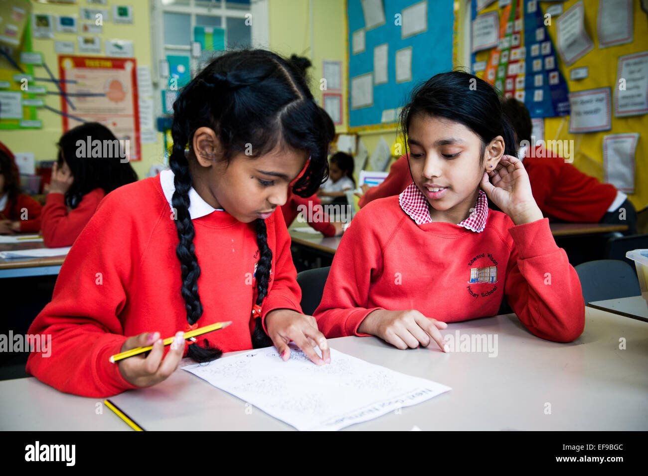 Asian girls studying in London Primary School classroom Stock Photo