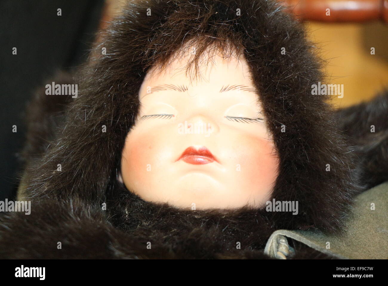 a native baby doll dress in fur, pretty face , baby face , hand made doll Stock Photo
