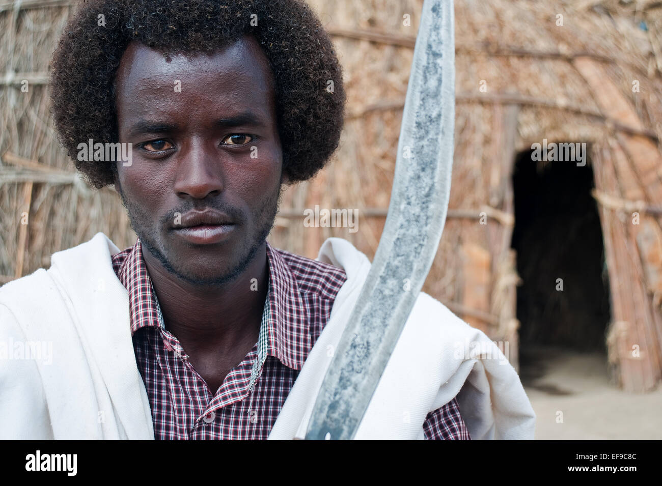 Young man belonging to the Kereyu tribe holding his knife ( Ethiopia