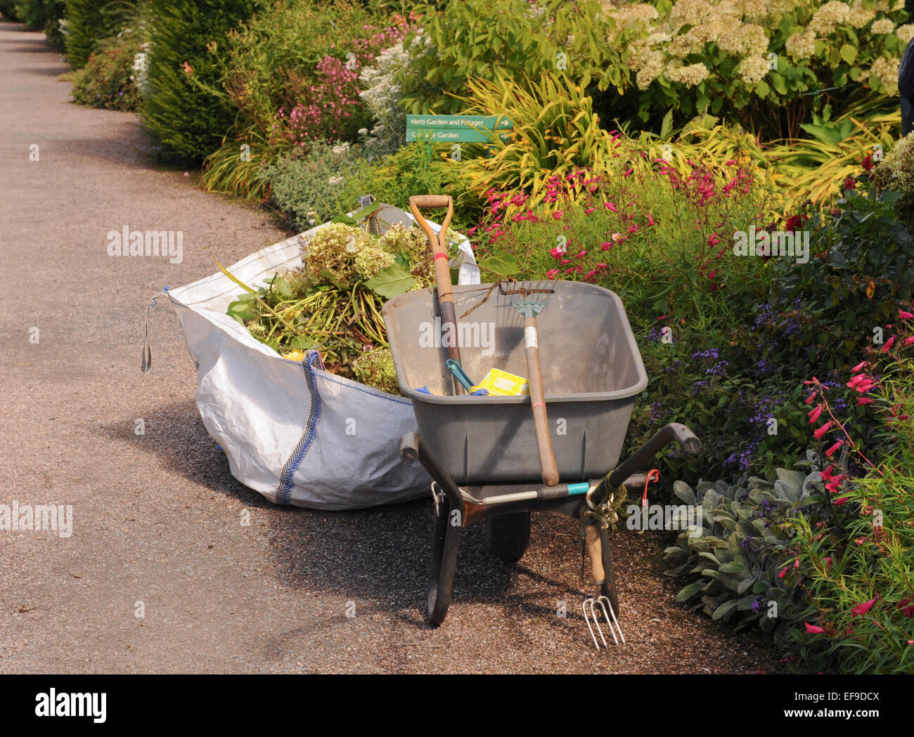Wheelbarrow and Gardening Tools in the Gardens at Rosemoor, Devon
