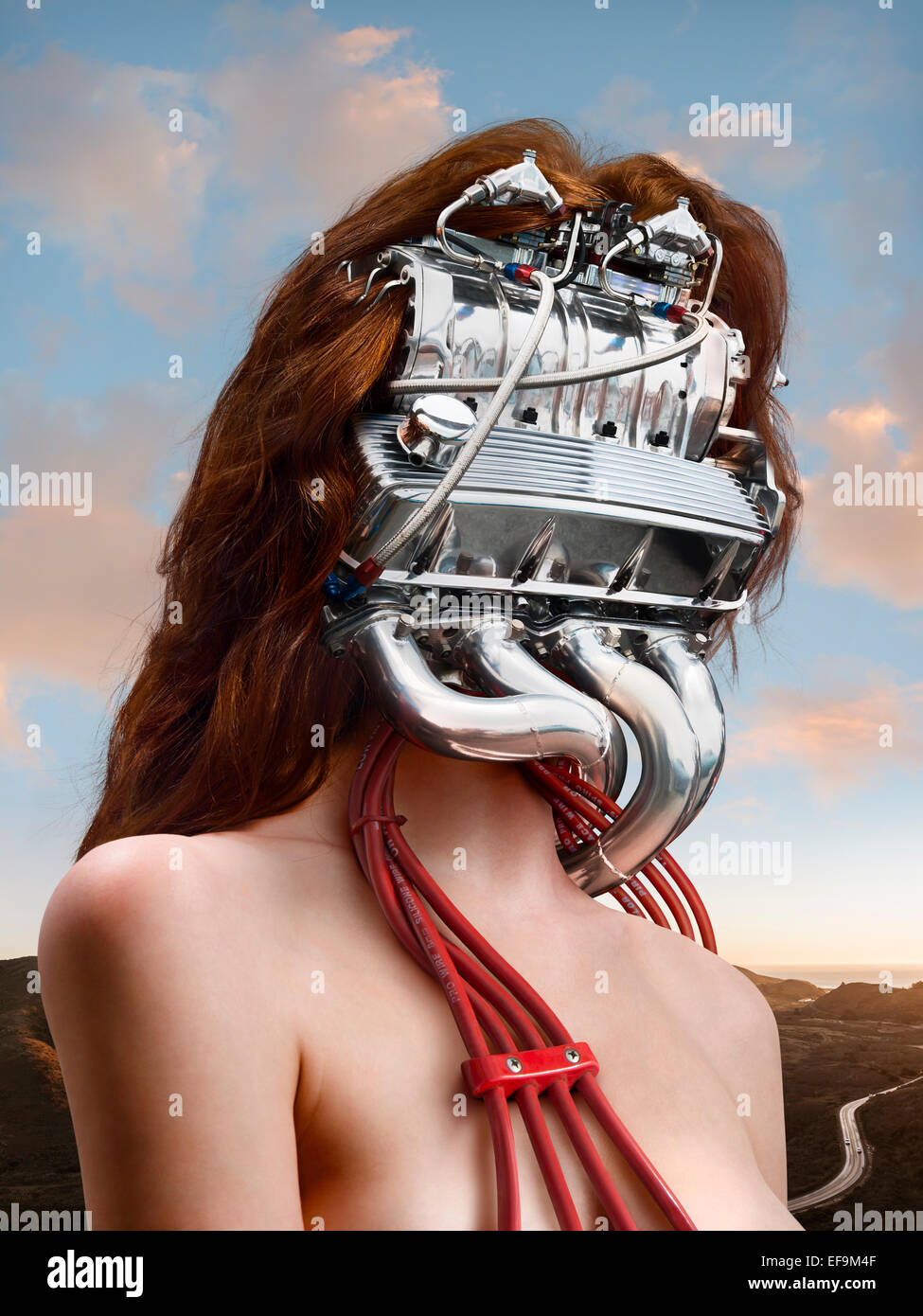 Fantasy image of woman with a car engine for a head with a sunset lit landscape behind her Stock Photo