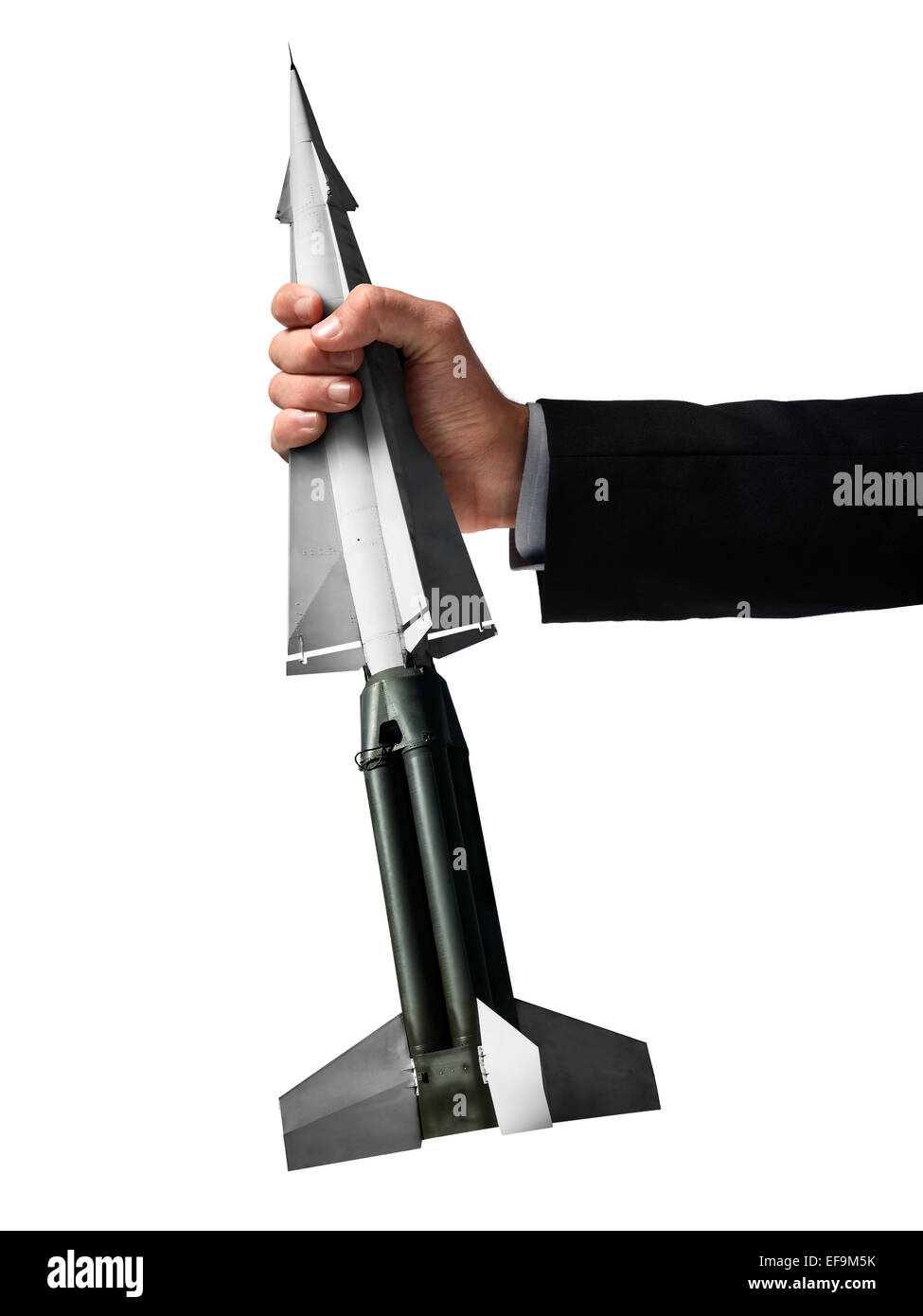 Nuclear missile being grasped by a giant hand against white background Stock Photo