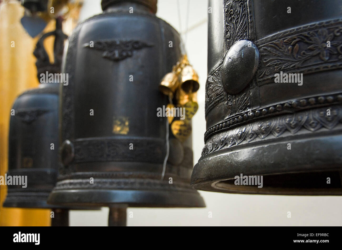 Horizontal view of Buddhist prayer bells hanging at Wat Doi Suthep in Chiang Mai. Stock Photo