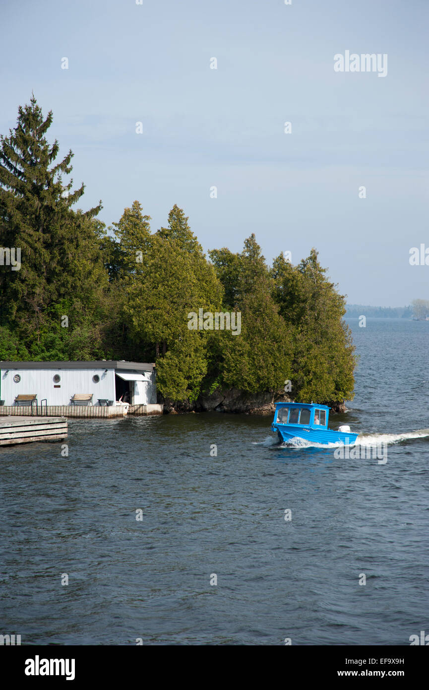 Boat on St. Lawrence River approaching land, Thousand Islands Region, Gananoque, Ontario, Canada Stock Photo