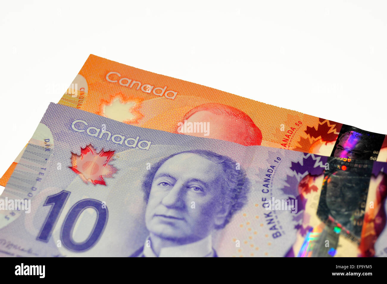 Canadian $50 and $10 currency notes photographed against a white background. Stock Photo