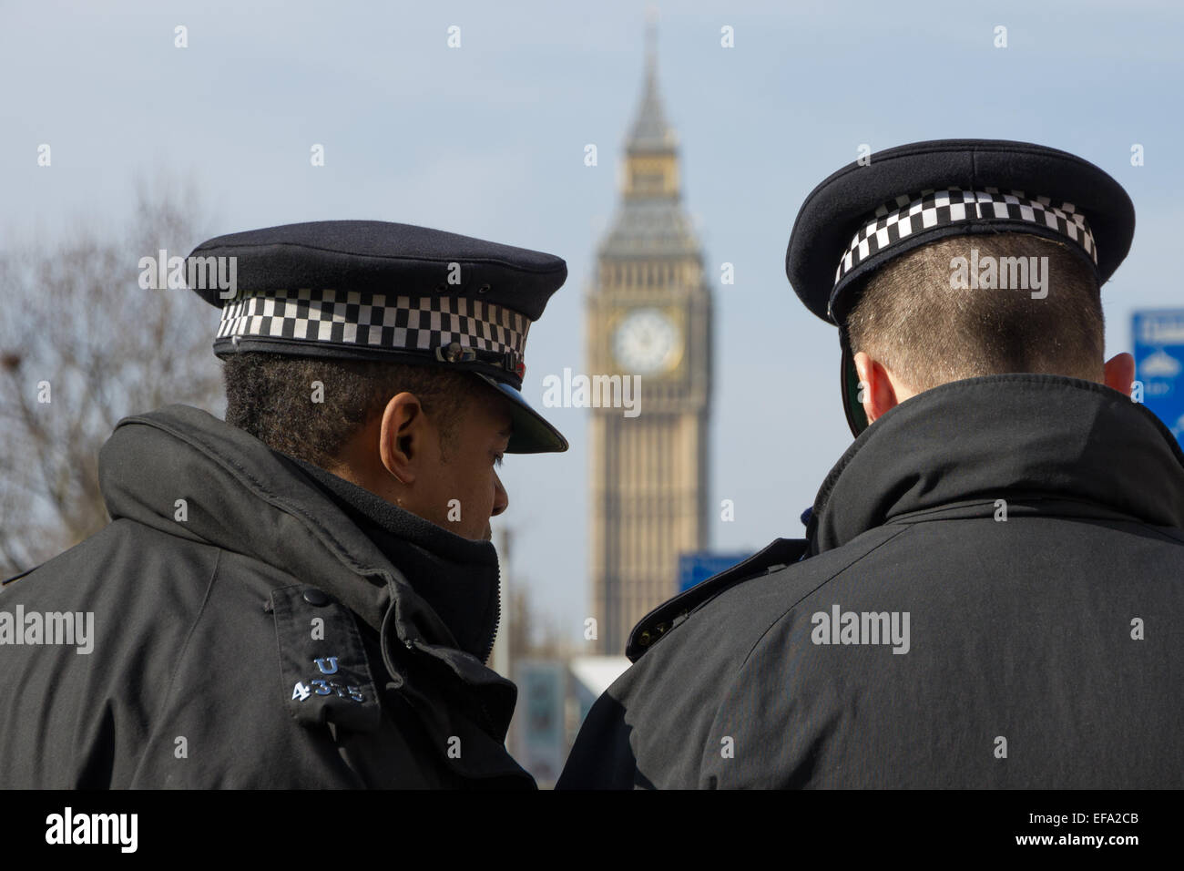 Two London Metropolitan Police Officers overlooking Big Ben Stock Photo
