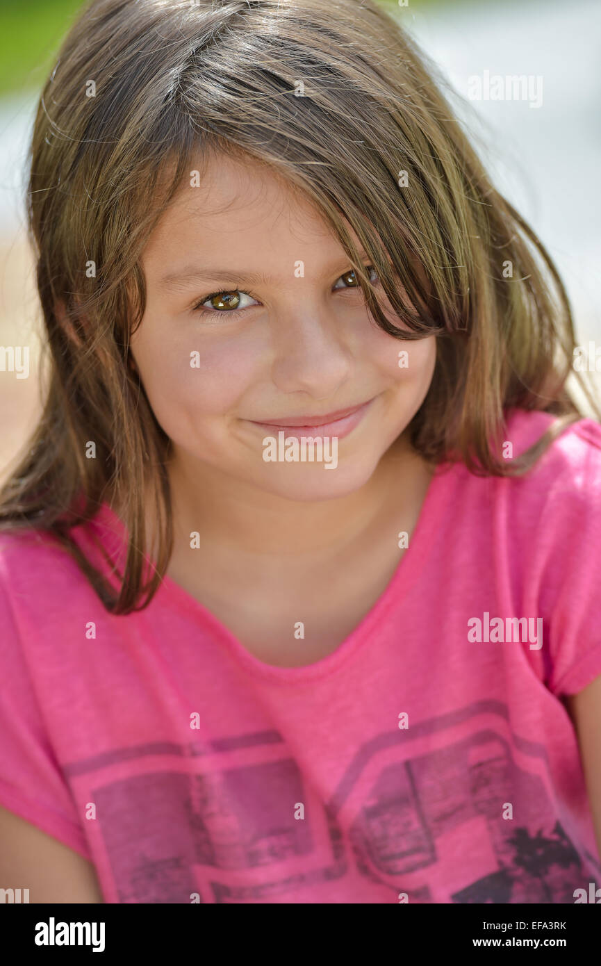 Adorable preteen smiling in natural light Stock Photo