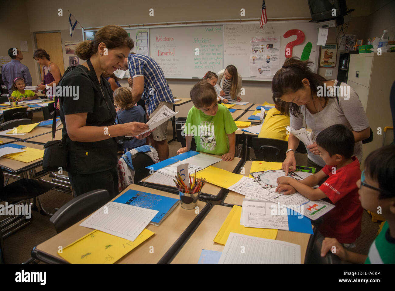 Parents and children mix in an Irvine, CA, elementary school classroom on parents day. Note welcome sign in background. Stock Photo