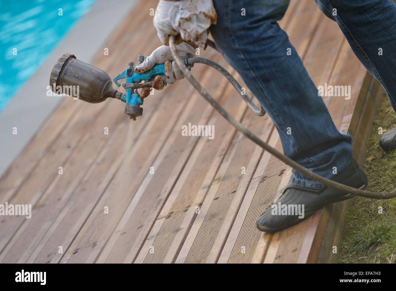 Spraying wood deck with spray gun Stock Photo Alamy