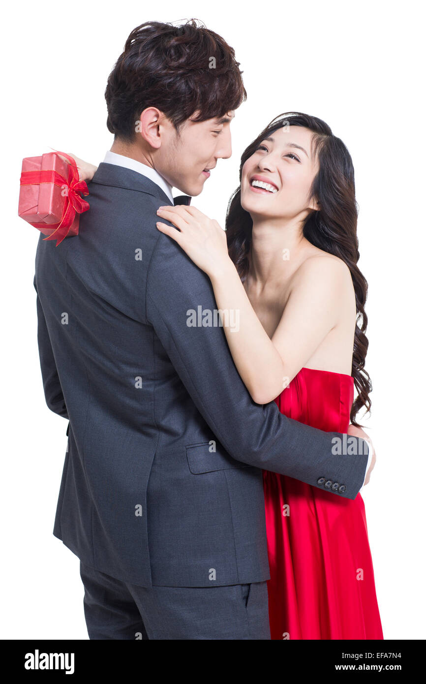 Young woman hugging boyfriend after receiving a gift Stock Photo - Alamy