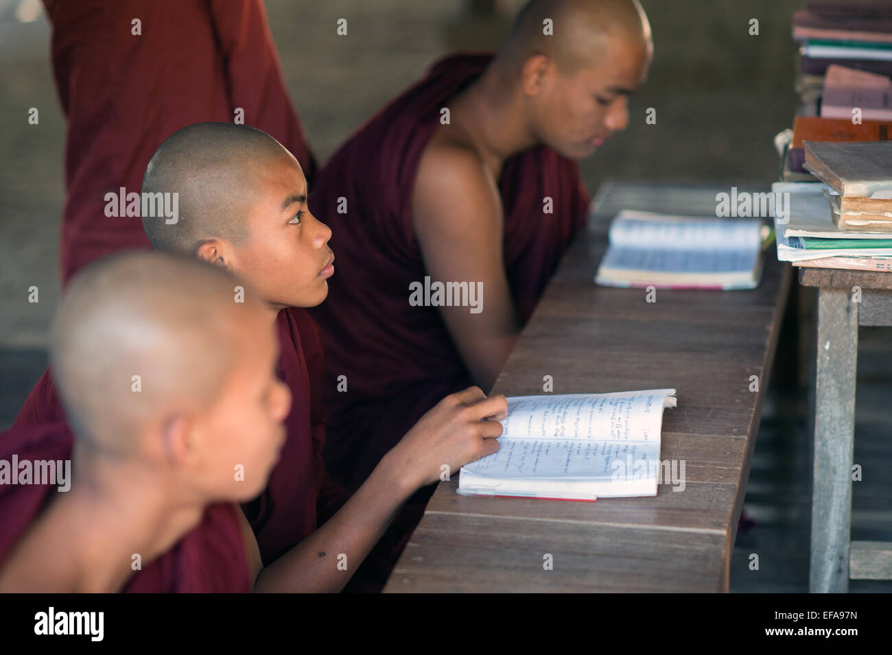 Young Burmese novice monks study books in a monastery in Bagan. Stock Photo