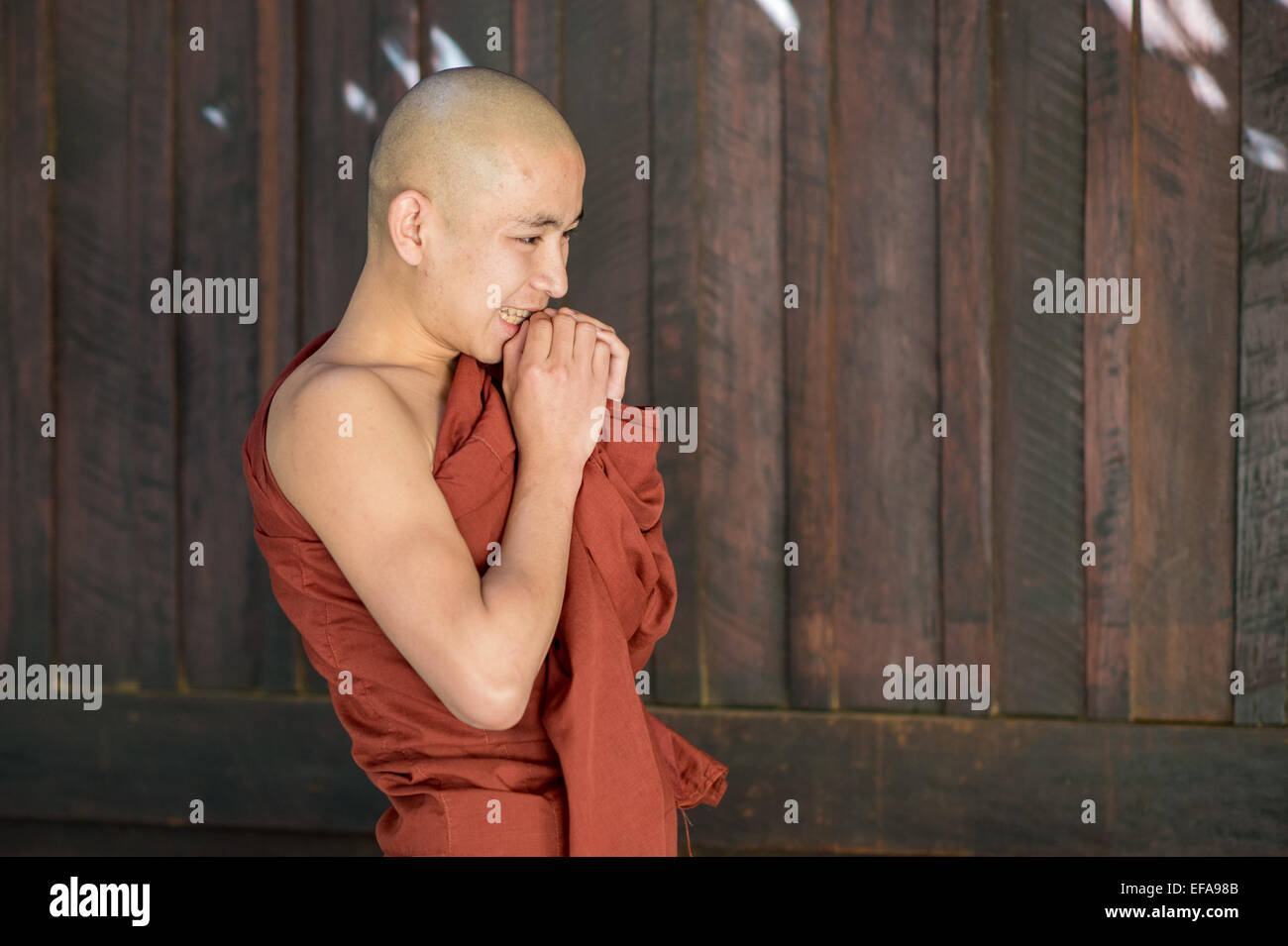 Young Burmese novice monk asking his teacher a question. Buddhists in Myanmar belong mainly to the Theravada tradition. Stock Photo