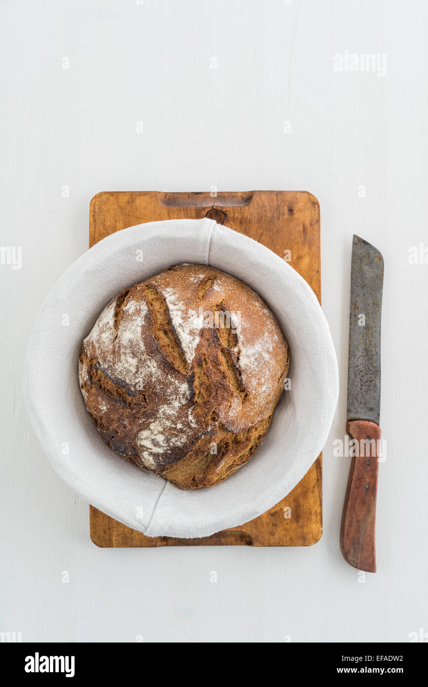 Rustic sourdough bread and knife Stock Photo