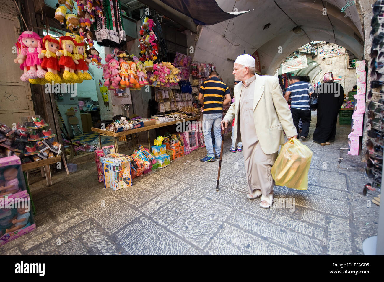 JERUSALEM, ISRAEL - OCTOBER 07, 2014: People are walking in one of the small streets in the old city of Jerusalem Stock Photo