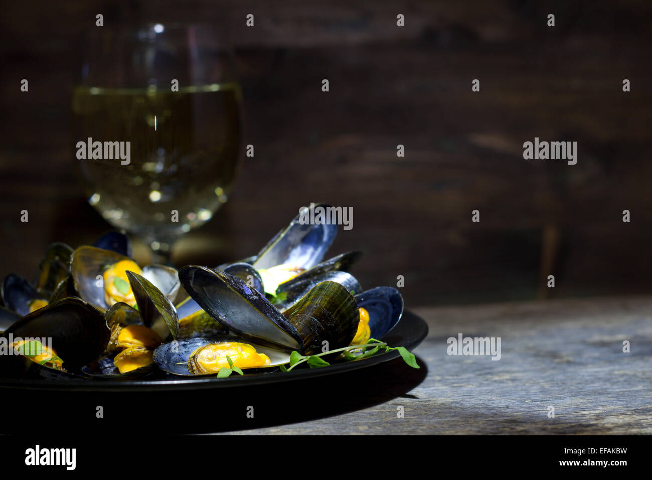 Mussels with glass of white wine and thyme in the dark Stock Photo Alamy