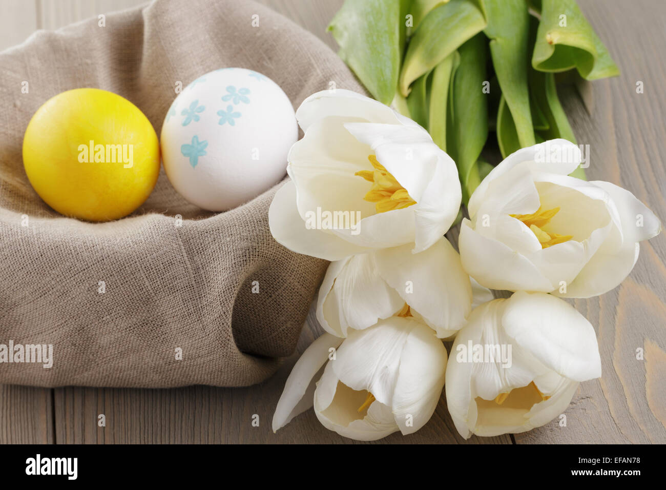 handpainted easter eggs and white tulips on wood table Stock Photo - Alamy