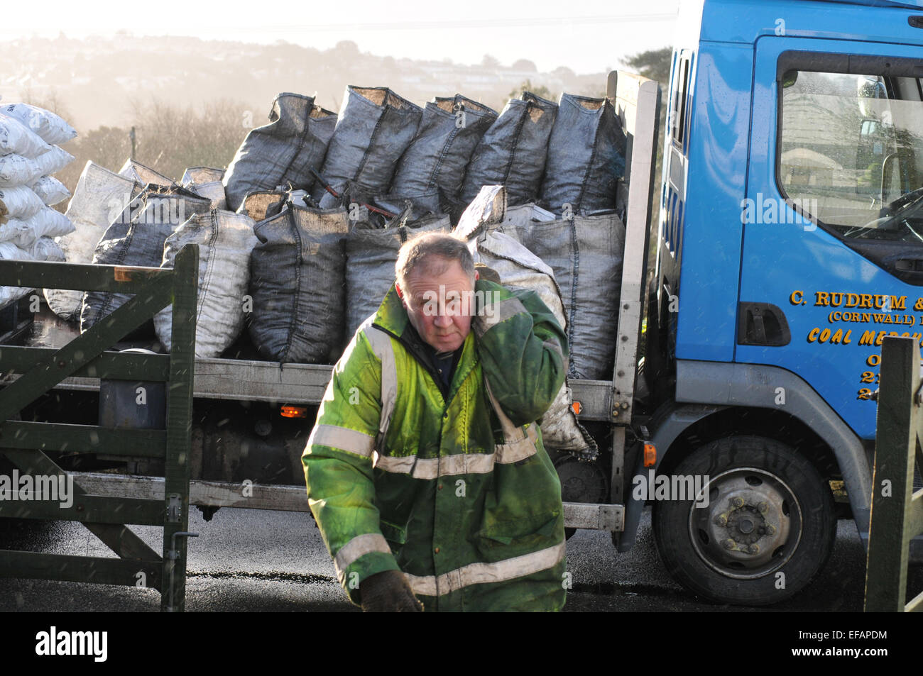 Man delivering sacks of coal, Cornwall, England, UK Stock Photo