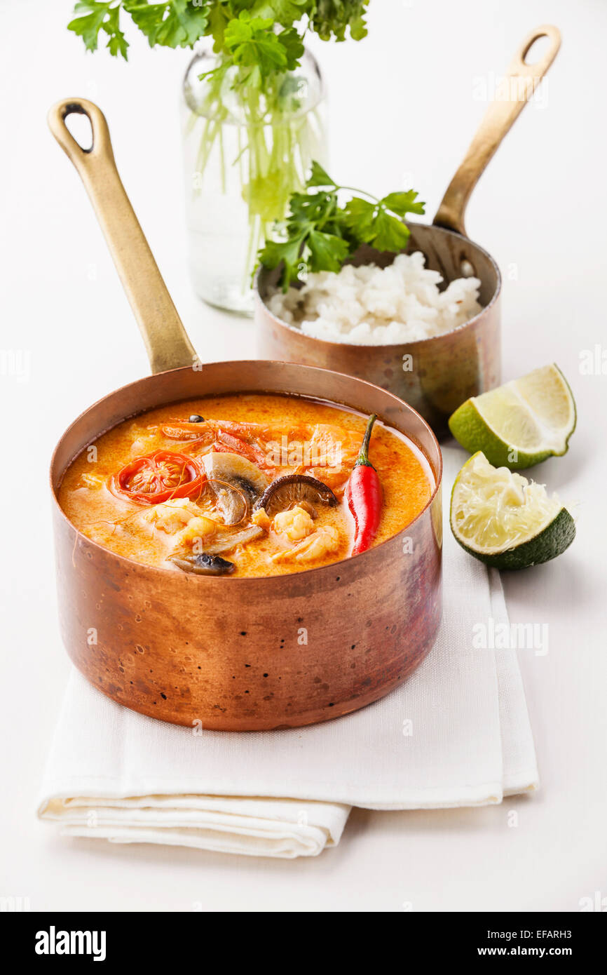 Spicy Thai soup Tom Yam with Rice and Seafood on white background Stock Photo