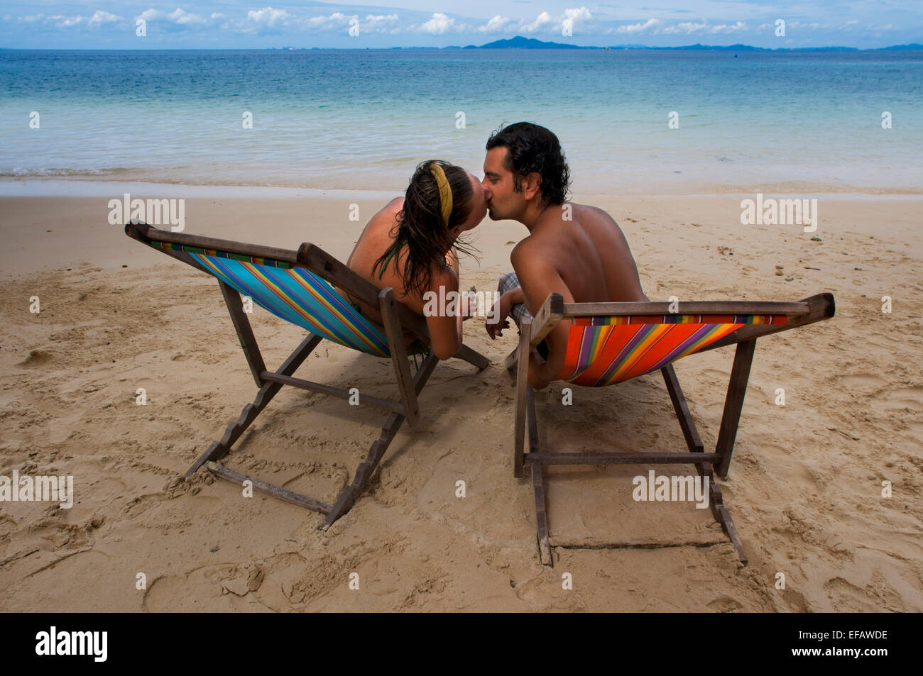 Couple lovers kissing in a hammock on the beach. Phi Phi don. Relax Beach. Phak Nam Bay. Thailand. Asia. Phi Phi Don island. Kra Stock Photo