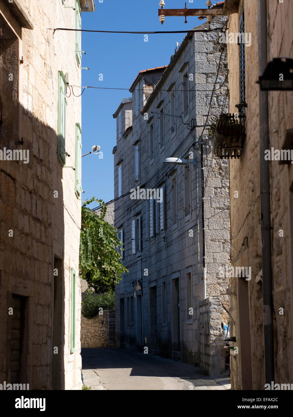 Stone streets and old stone building exteriors on island Vis in Croatia Stock Photo