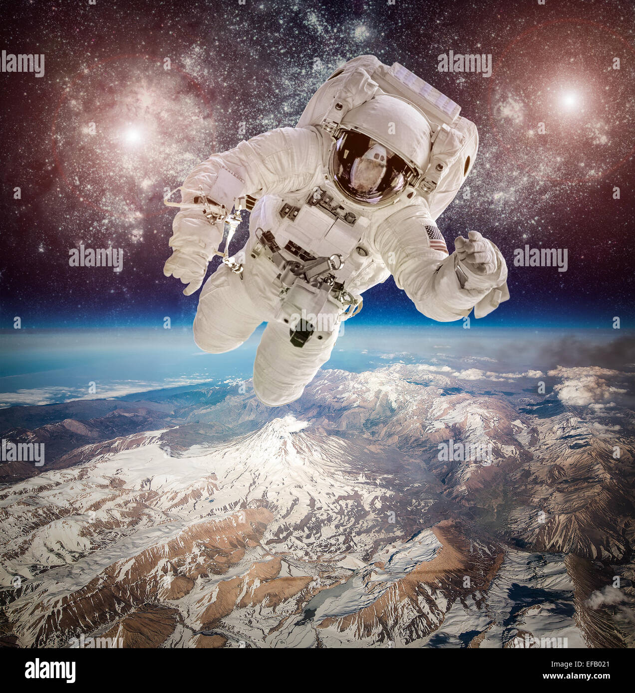 Astronaut in outer space against the backdrop of the planet earth. Elements of this image furnished by NASA. Stock Photo