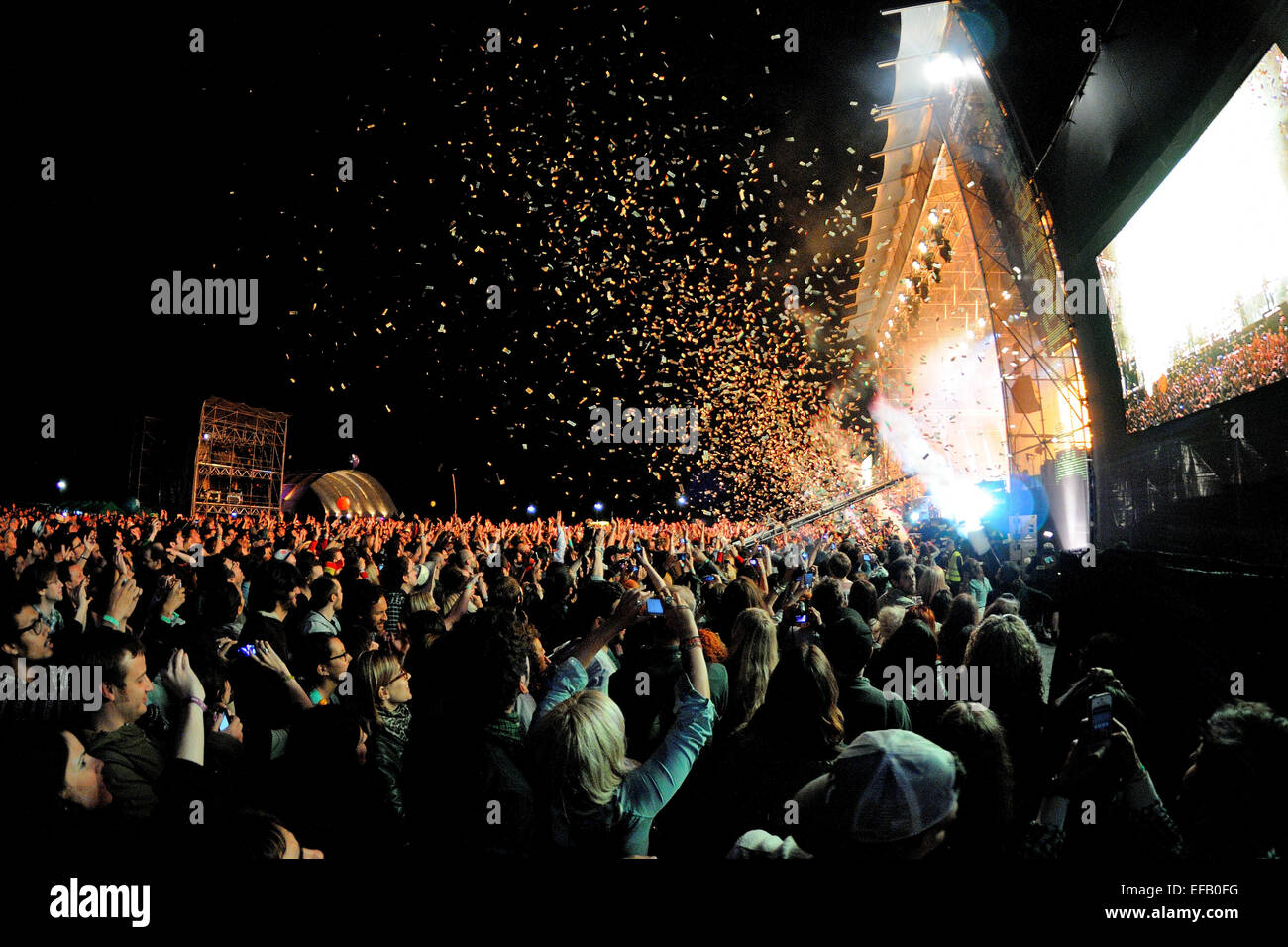 BARCELONA - MAY 23: Audience watch a concert, while throwing confetti from the stage at Heineken Primavera Sound 2013 Festival. Stock Photo