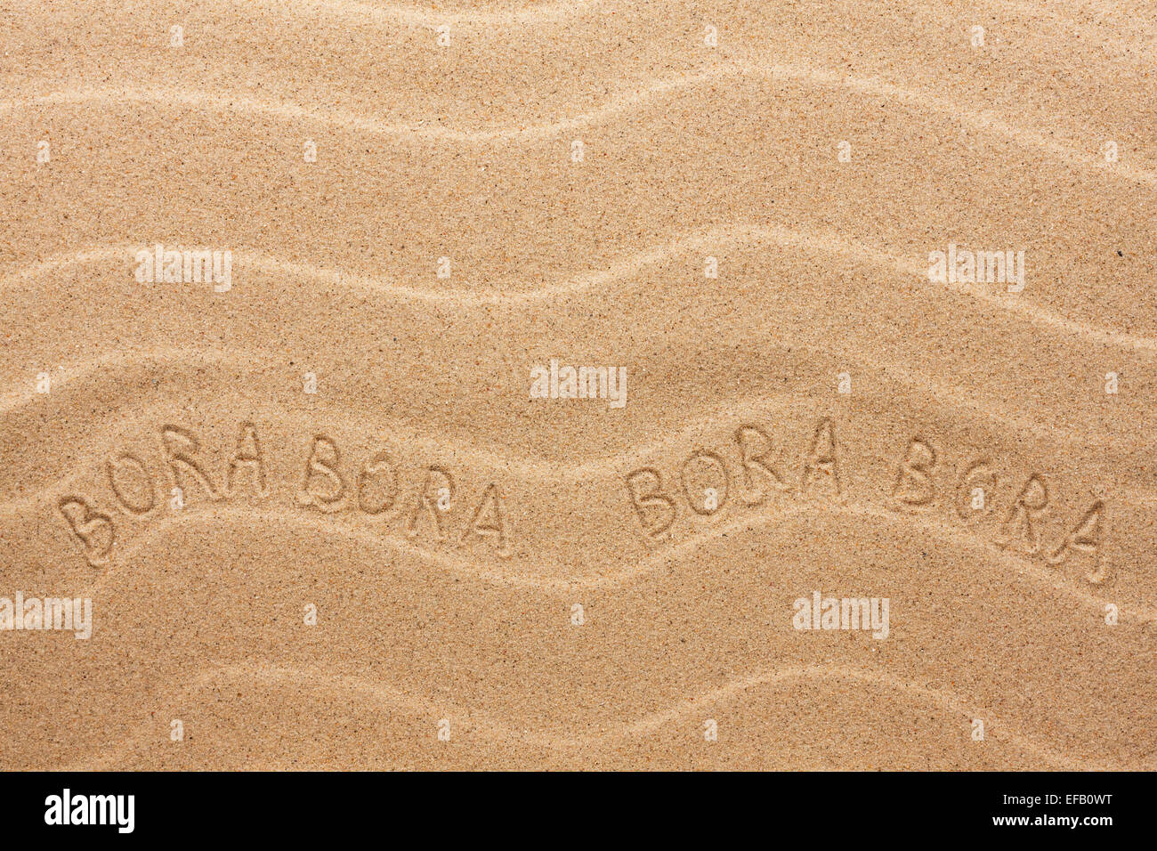 Bora Bora inscription on the wavy sand, as background Stock Photo