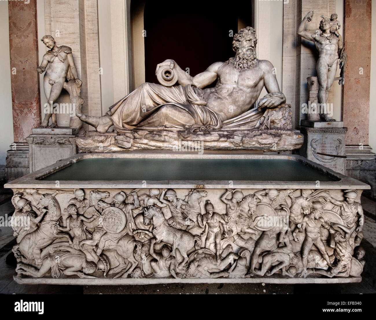 Divinity river (Arno) Ancient Roman statue of a river 16th century  Giovanni Angelo Montorsoli, who gave it the attributes of river Tigris Octagonal Courtyard ( Marble sarcophagus, ca. 160–170 CE, showing a relief of an Amazonomachy (fight between Greek warriors and Amazons). Served as basin for the Tigris fountain )Museo Pio-Clementino  Vatican Museum Rome Italy Stock Photo