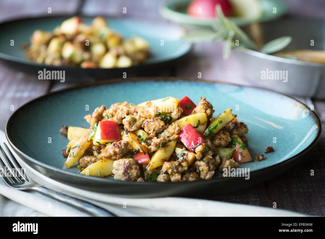 Spicy pork parsnip and apple dish with sage and parsley Stock Photo