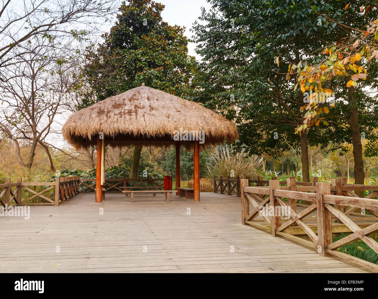 Wooden pathway and traditional Chinese gazebo. Walking around famous West Lake park in Hangzhou city, China Stock Photo
