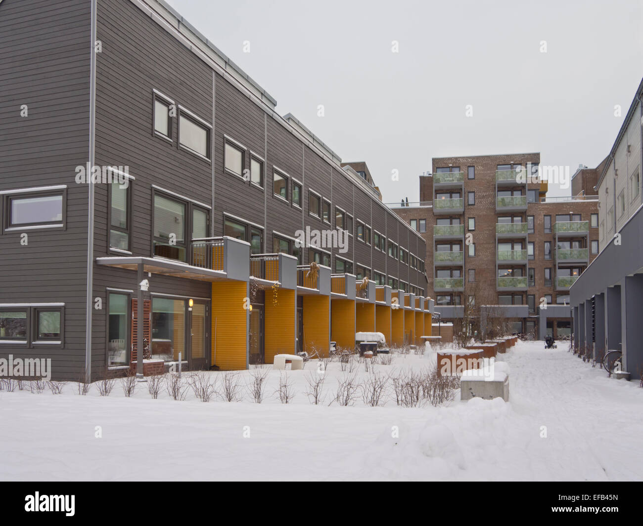 Modern apartment blocks with wooden details and a yellow accent , contemporary architecture in Oslo Norway Stock Photo