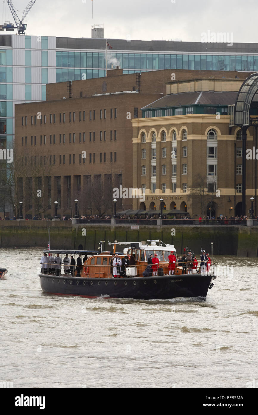 London, UK. 30th January, 2015. The Havengore, the boat which carried the coffin of Winston Churchill 50 years ago today, started the anniversary event by making it's way along the River Thames from Tower Bridge to Westminster. On its journey passing HMS Belfast, the WW2 battleship which is moored on the Thames. Credit:  Steve Hickey/Alamy Live News Stock Photo