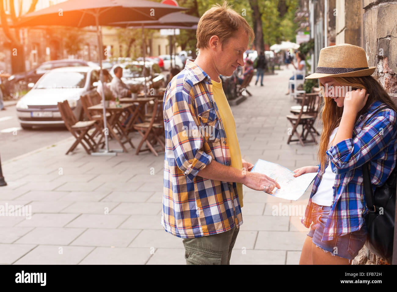 Young couple attractive tourist watching map. Dating and tourism concept. Summer holidays. Stock Photo