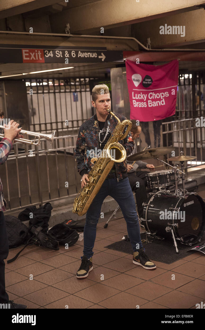 Underground Music: Lucky Chops Brass Band performs at the 34th Street subway station in Manhattan under Manhattan Mall. Stock Photo