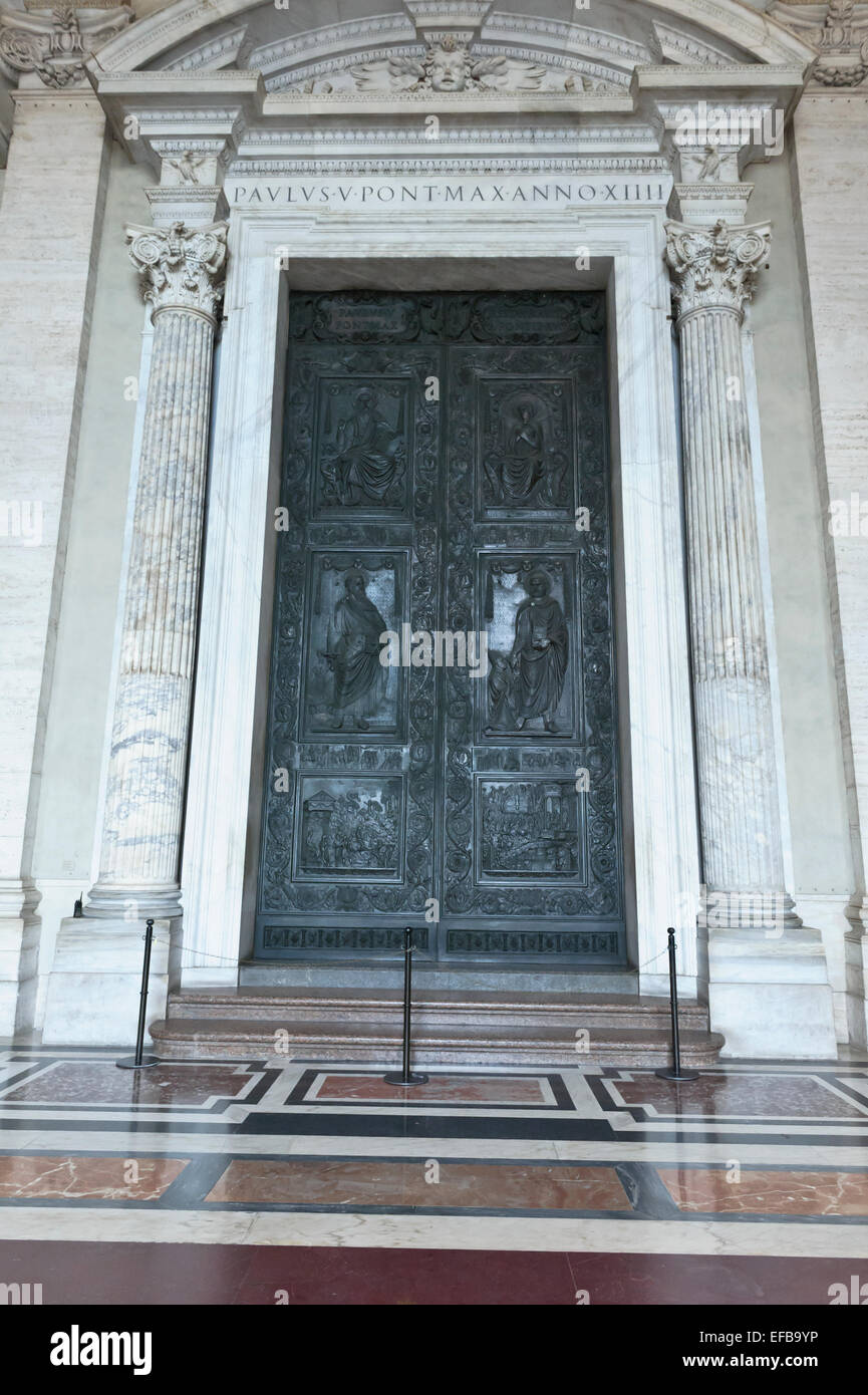 A decorative steel door with religious carvings at the entrance of the
