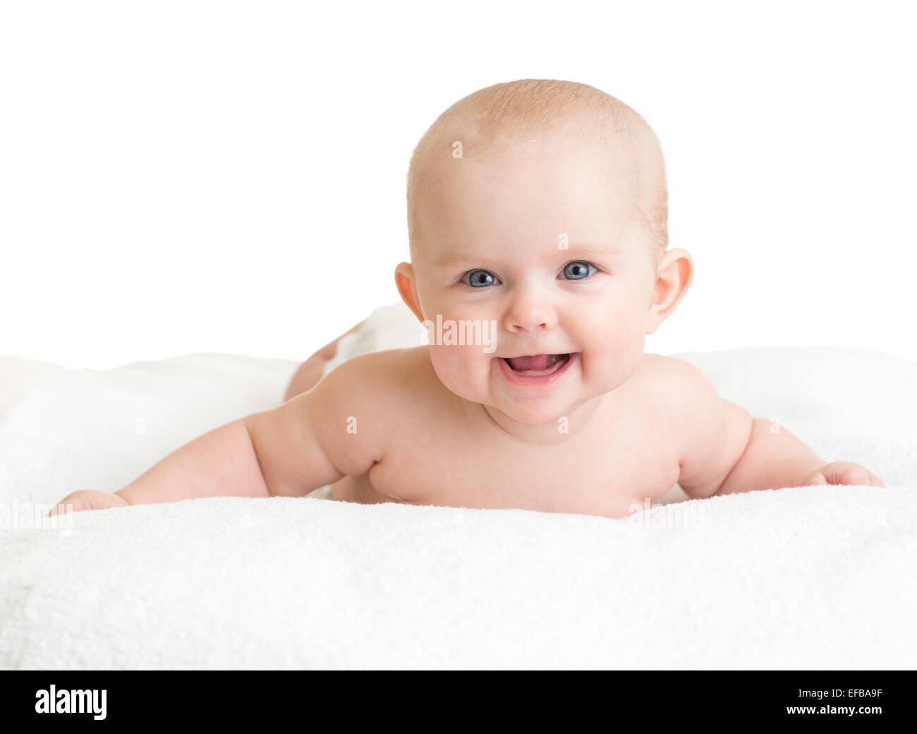 Cute smiling baby lying on white towel Stock Photo