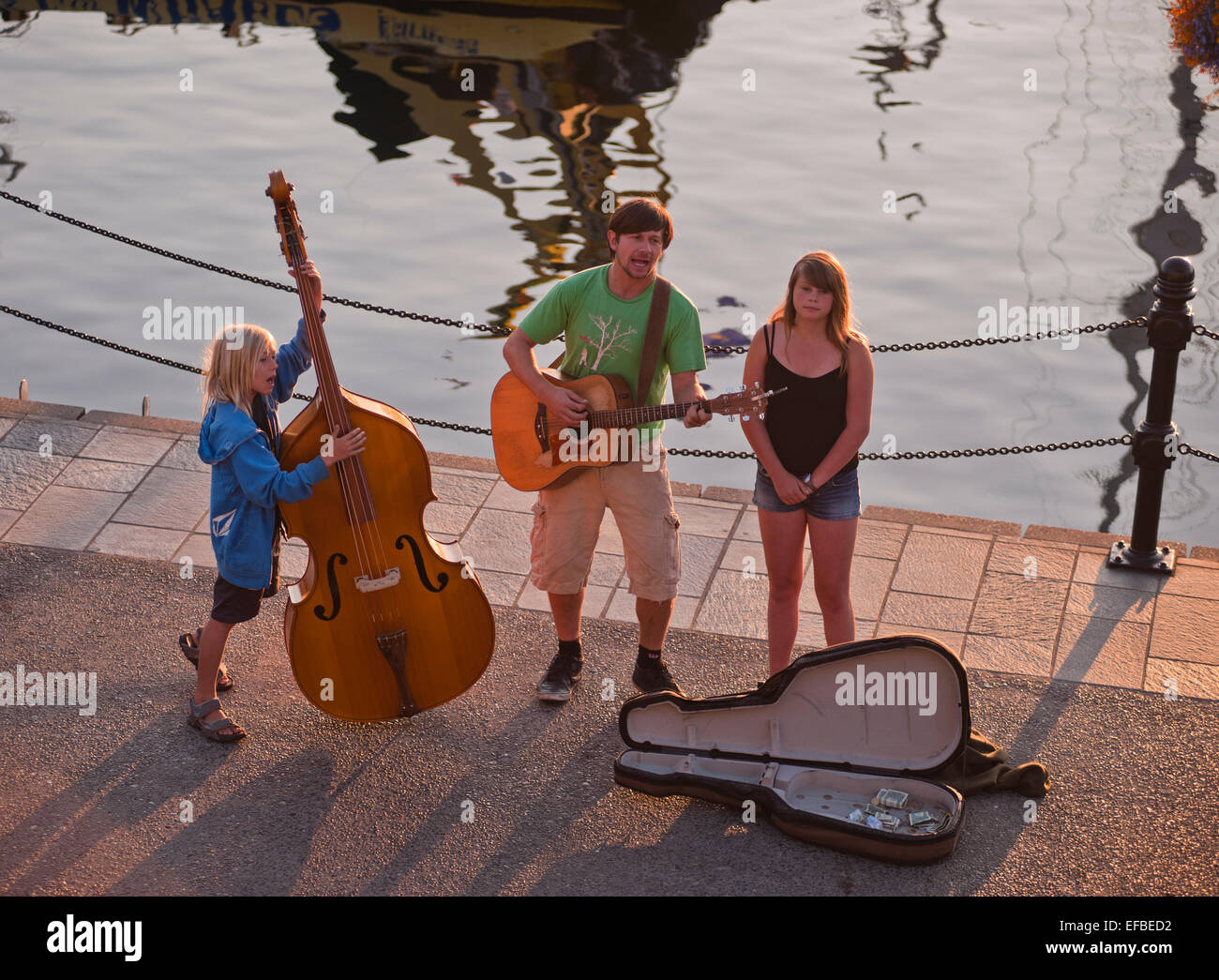Buskers performing music on the waterfront of the inner harbour, Victoria, British Columbia, Canada. Stock Photo