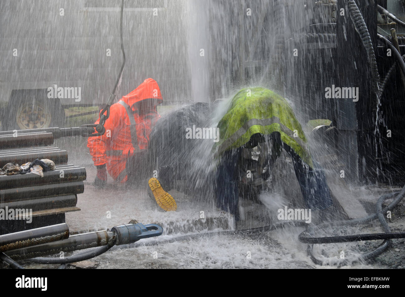 MOANA, NEW ZEALAND, MARCH 18, 2010: Drilling crewmen control a blowout at the mouth of a well for coal seam  gas near Moana Stock Photo