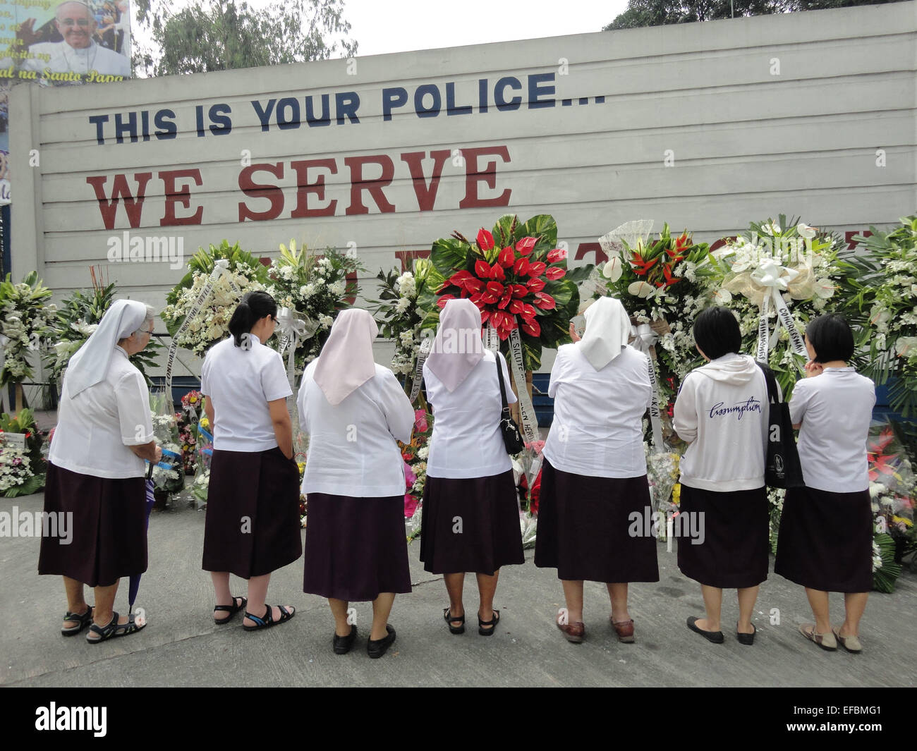 Nuns from the Religious of the Assumption pray outside the Philippine National Police headquarters, in memory of the 44 elite commandos who were killed in an encounter against Moro seperatist rebels. Philippine President Benigno Aquino III declared a National Day of Mourning to commemorate the 44 elite commandos who were slain in an encounter at Mamasapano, Maguindanao province. © Richard James Mendoza/Pacific Press/Alamy Live News Stock Photo