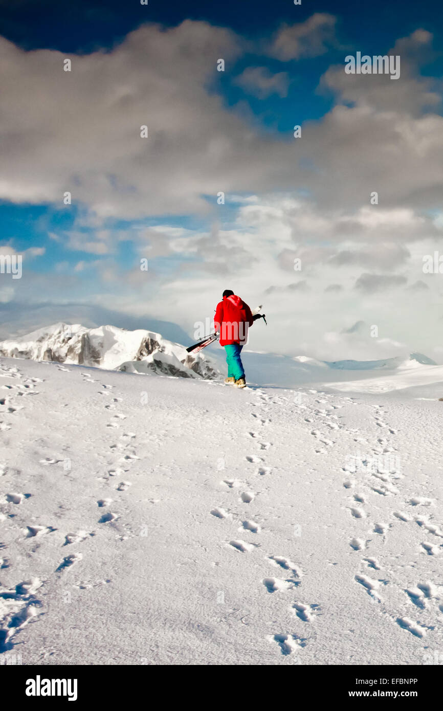 Man climbs on a snow slope Stock Photo