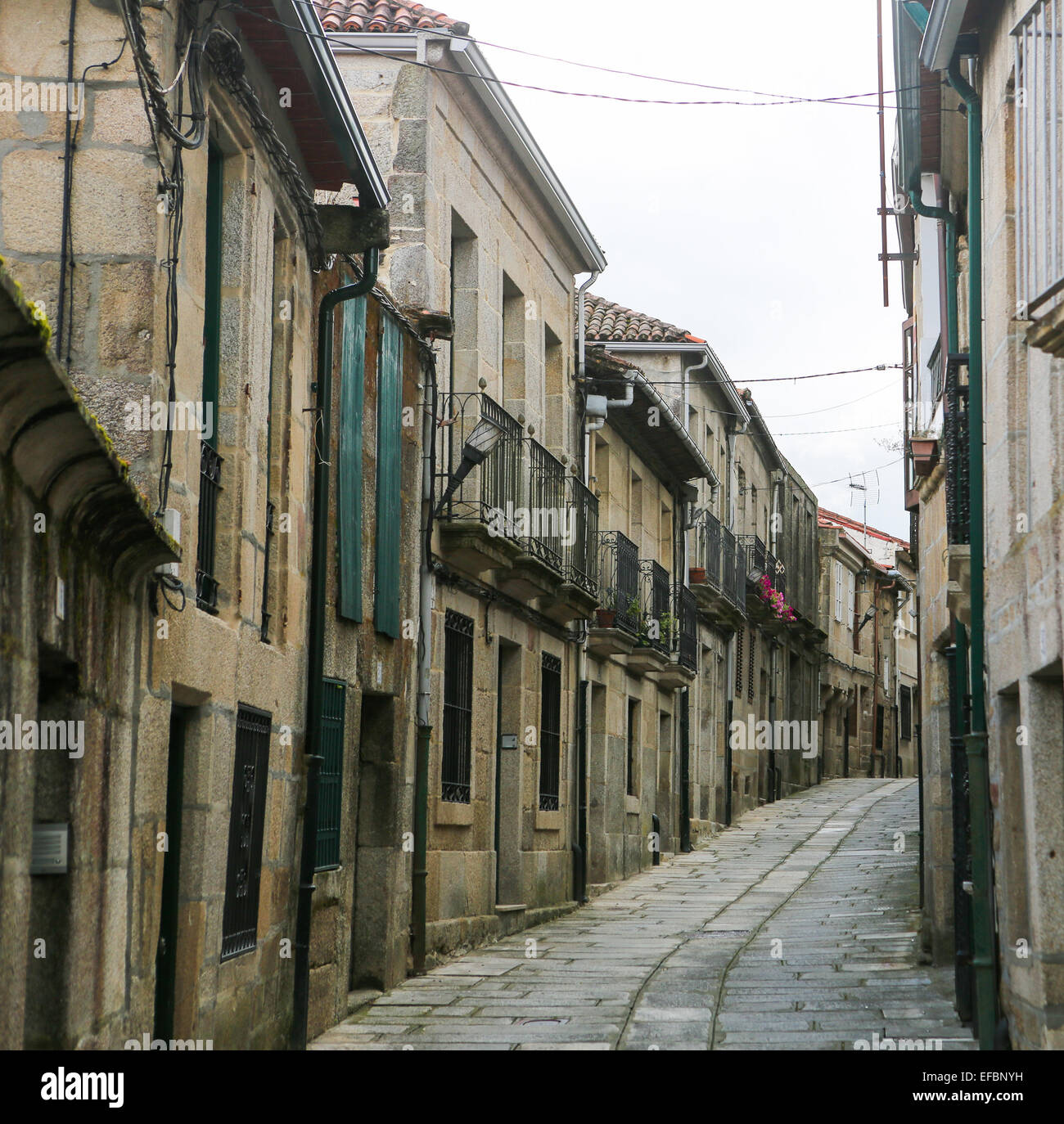 Narrow street in the old center of Tui, a border town with Portugal in ...