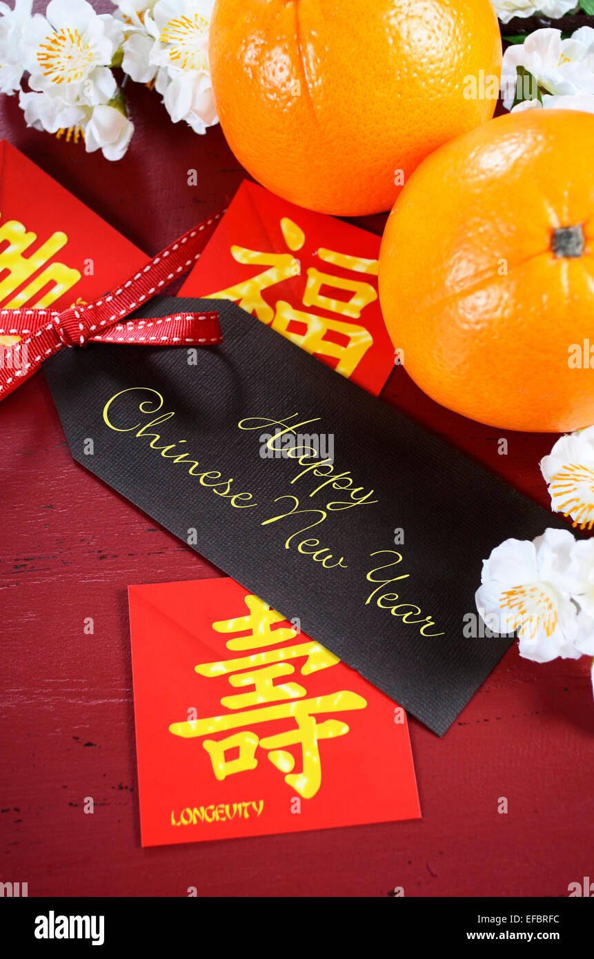 Happy Chinese New Year celebration party table on red wood background. Stock Photo