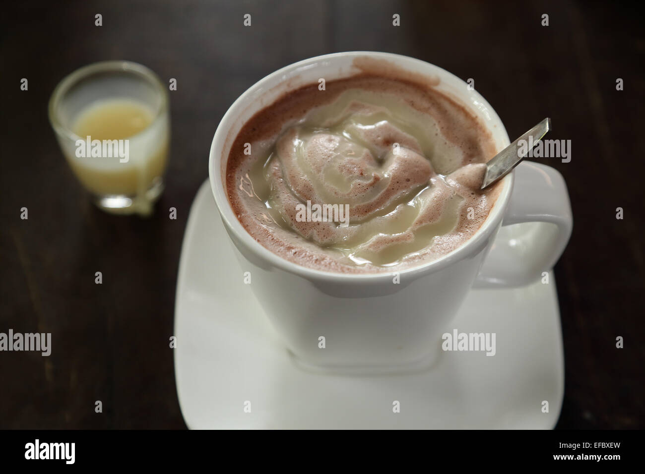 Hot chocolate milk in a white cup with sweetened condensed milk Stock