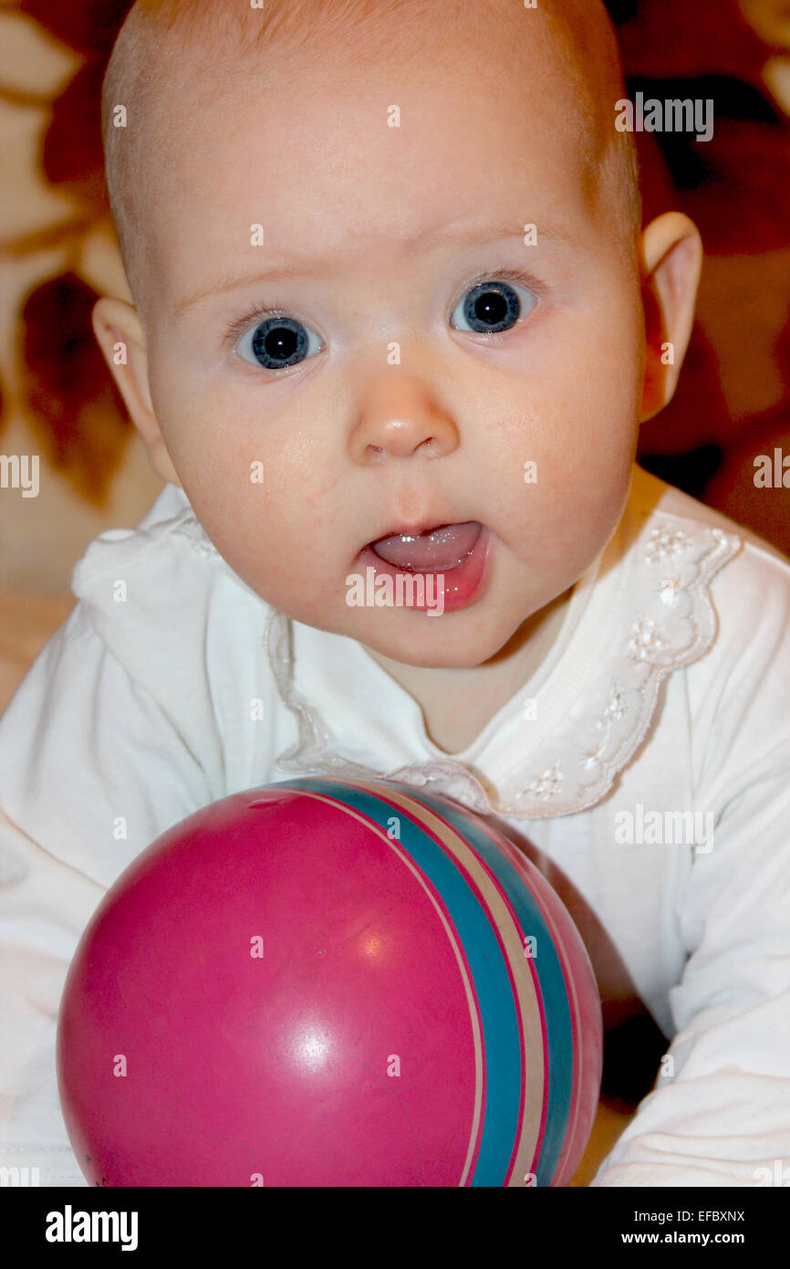 beautiful little baby playing with red ball Stock Photo Alamy