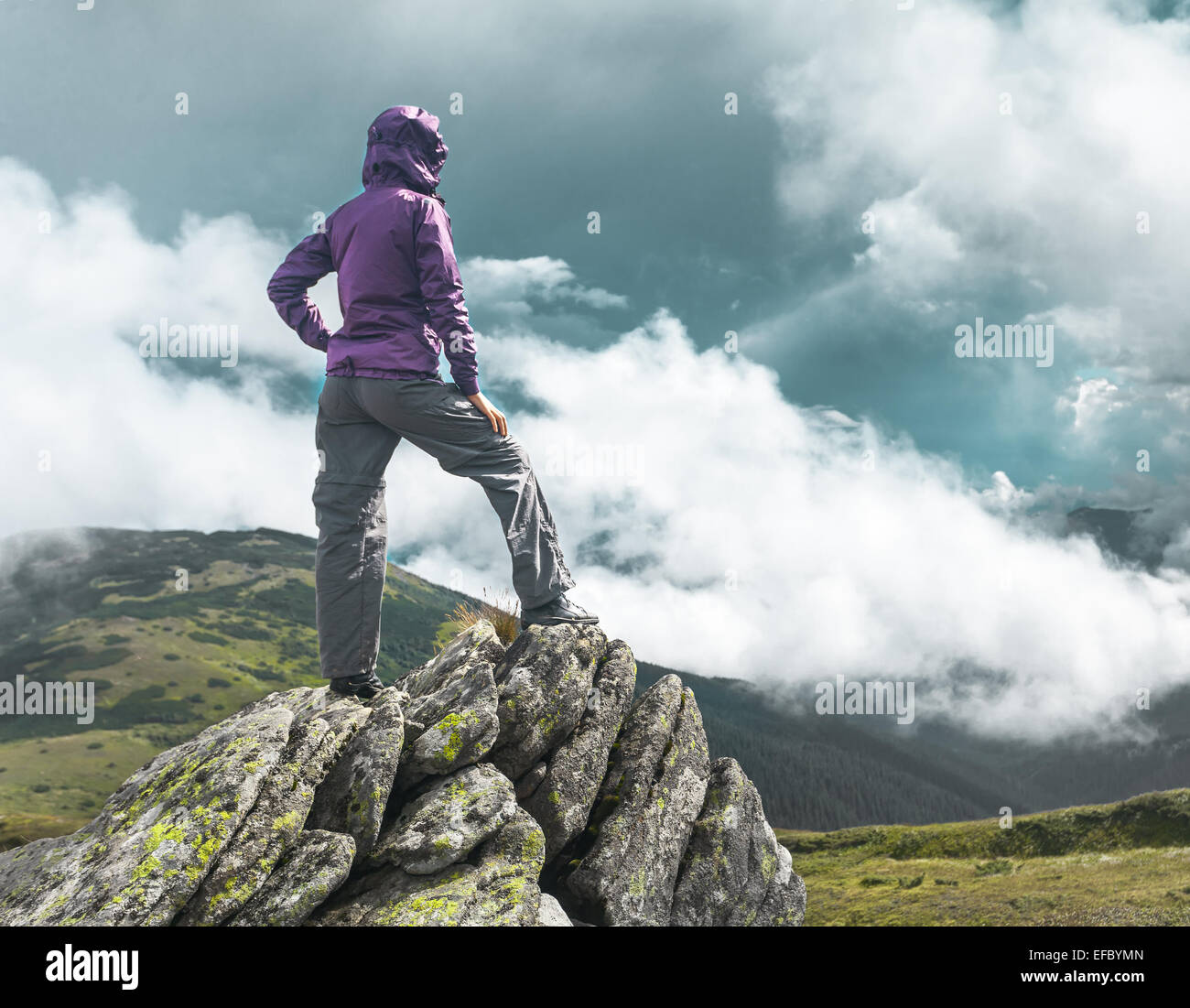 Woman on top of a mountain Stock Photo