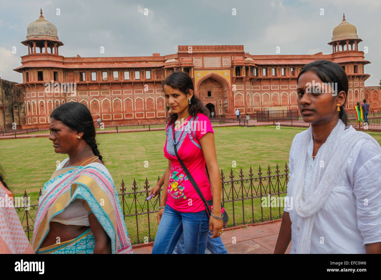 Women passing in front of  Jahangir Mahal, inside Agra Fort complex, Uttar Pradesh, India. Stock Photo