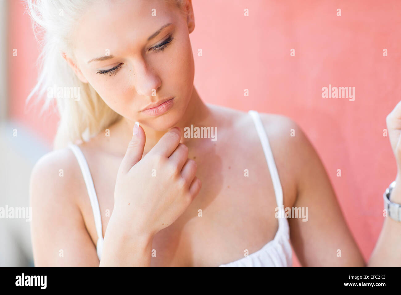 Concerned blonde teenage girl outdoor Stock Photo