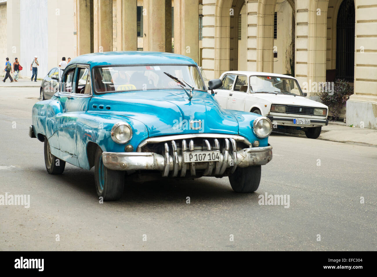 Cuba Old Havana La Habana Vieja Calle Zulueta moving old classic vintage 1950's American car taxi cab passengers pale blue Buick Stock Photo