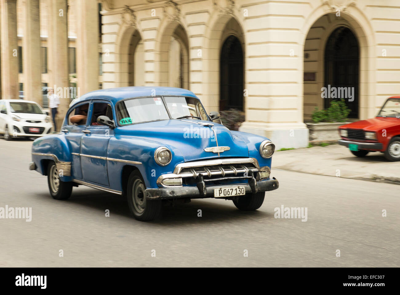 Cuba Old Havana La Habana Vieja Calle Zulueta moving old classic vintage 1950's American car taxi cab dark blue Chevy Chevrolet Stock Photo